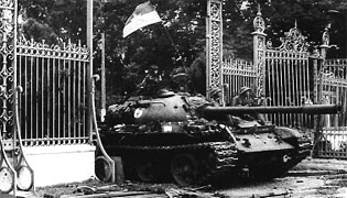 North Vietnamese tanks crash through the gates of the presidential palace in Saigon